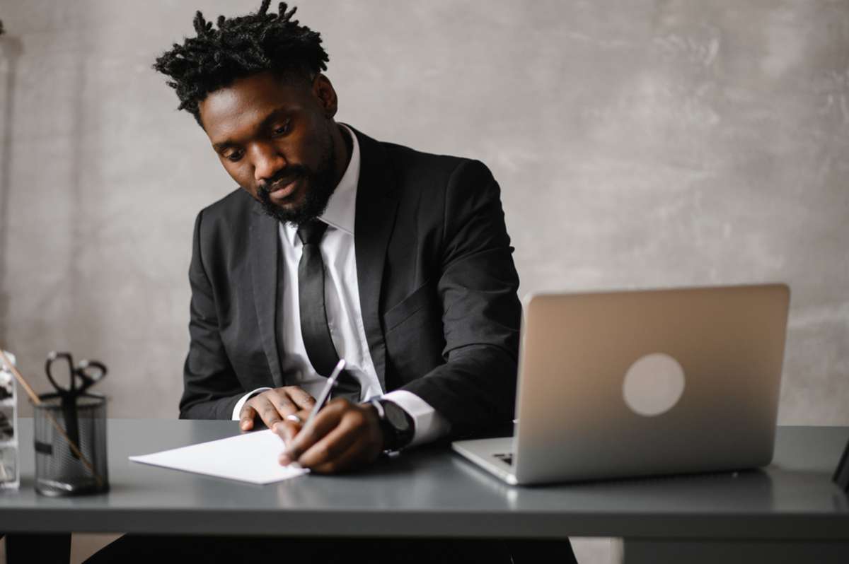 A business professional at a desk with a laptop, Chicago commercial real estate investing concept