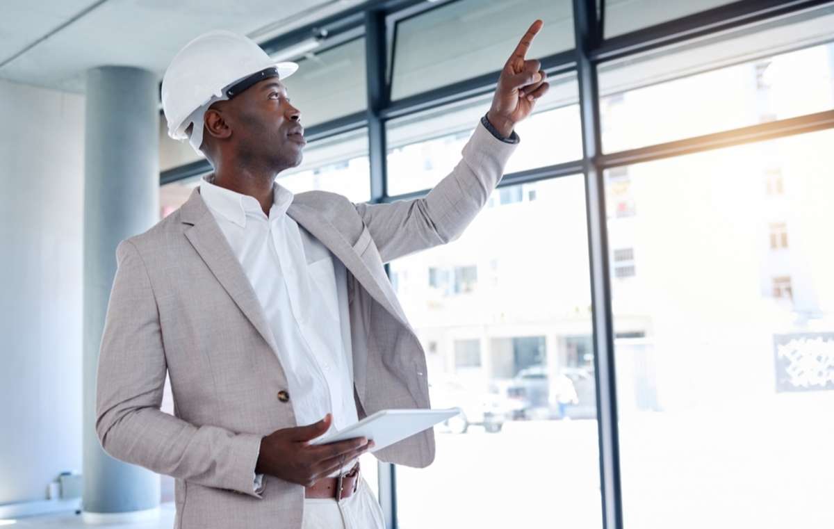 Businessman in a hard hat looks for building upgrade opportunities for the real estate Chicago suburbs offers